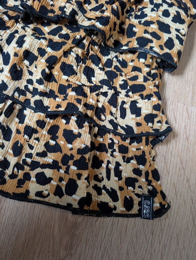 Close-up of the camel leopard ruffle skirt fabric and tiers