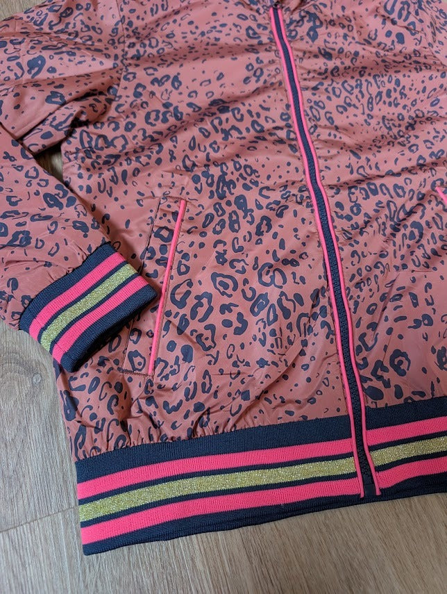 The brown panther jacket laid flat showing the striped cuffs and hem